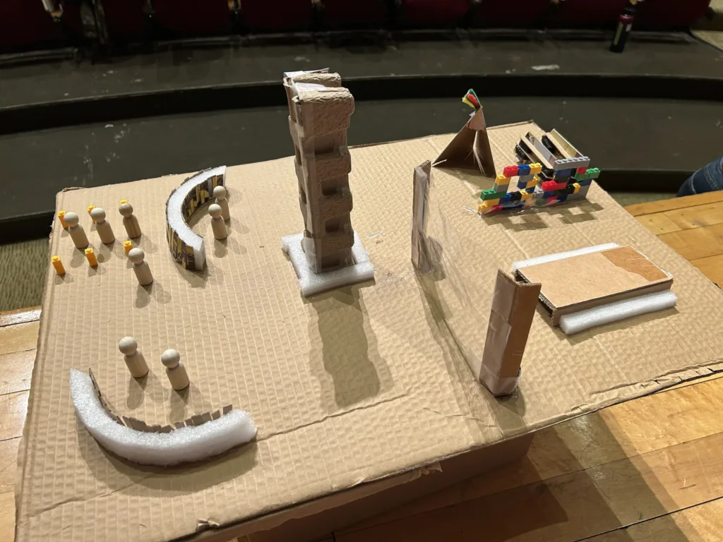 cardboard prototype of a library space. there are mini figures, styrofoam furniture, and lego structures. Boston service jam